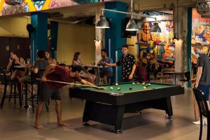 a group of people playing a game of billiard at Abraham Tel Aviv in Tel Aviv