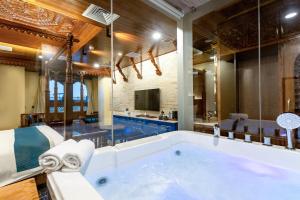a large bathroom with a large soaking tub at Aarya Hotel and Spa - Eternal Heritage in Kathmandu