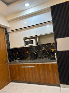 a kitchen with a microwave above a counter at Rao Studio in Noida