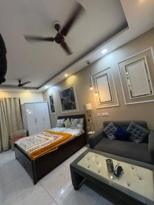 a bedroom with a bed and a couch at Rao Studio in Noida
