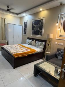 a bedroom with a large bed and a couch at Rao Studio in Noida