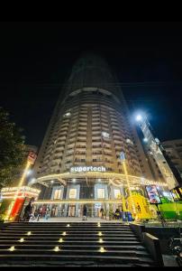 a large building with stairs in front of it at night at Rao Studio in Noida