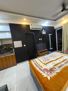 a bedroom with a large bed and a television at Rao Studio in Noida +20 photos
