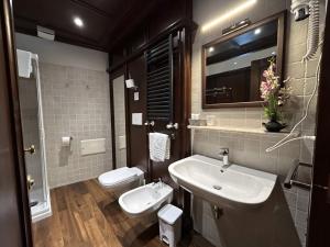a bathroom with a sink and a toilet at Mario Number 8 in Verona +36 photos