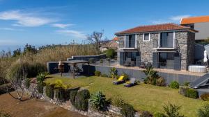 a house with a yard with a lawnitures at Casa da Felicidade by LovelyStay in Prazeres