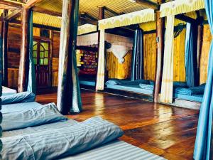 a room with two beds and a wooden floor at Homestay Mường Lay in Bản Pong +9 photos