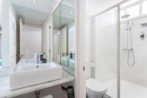 a white bathroom with a sink and a shower at Gold By Marina - Adults only in Playa del Ingles