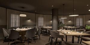a dining room with tables and chairs and lights at Hotel La Palloza in Lugo