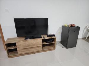 a flat screen tv sitting on top of a wooden entertainment center at Soares Stay in Tarrafal