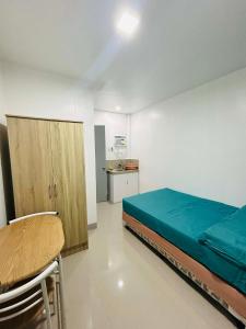 a room with a bed and a cabinet and a table at SiS B&B in San Jose +3 photos