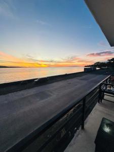 a view of a beach with a sunset over the water at SiS B&B in San Jose