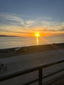 a sunset over a body of water with the sun setting at SiS B&B in San Jose