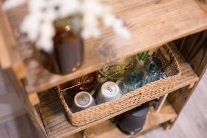 a wooden shelf with bottles of wine on it at wanderlust STAY in Kofu