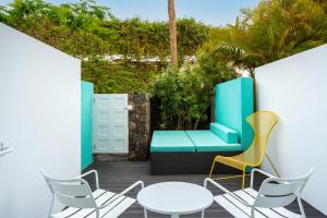 a patio with two chairs and a table at Gold By Marina - Adults only in Playa del Ingles