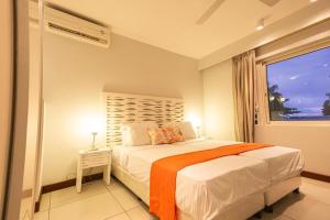 a bedroom with a large bed and a window at Seascape Villa in Pointe aux Biches +35 photos