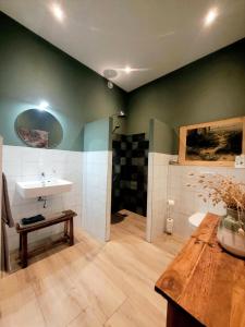 a bathroom with a sink and a counter and a table at 't Buitenverblijf Erve Punte in Losser +35 photos