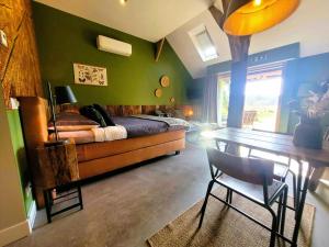 a bedroom with a bed and a table with a chair at 't Buitenverblijf Erve Punte in Losser