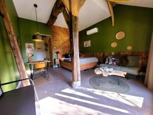a bedroom with a bed and a table in a room at 't Buitenverblijf Erve Punte in Losser