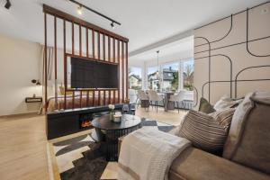 a living room with a couch and a fireplace at Modernes Design-Apartment am Drachenfels in Bad Honnef am Rhein