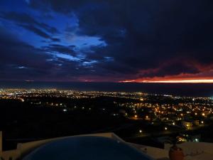 a view of a city lit up at night at Breathtaking Panoramic Villa Sea View Infinity Pool in Tala