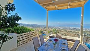 a dining table on a balcony with a view at Breathtaking Panoramic Villa Sea View Infinity Pool in Tala