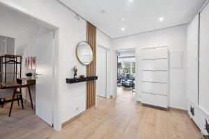 a hallway with white walls and a mirror and a table at Modernes Design-Apartment am Drachenfels in Bad Honnef am Rhein +26 photos