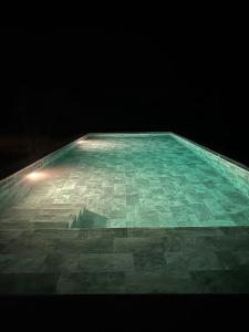 a large glass floor with a light on top of it at Baobab Beach Villa in Abémé