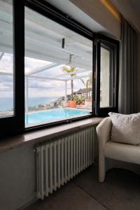 a room with a window with a view of a swimming pool at MEDITERRANEAN SEASONS, VILLA MEDITERRANEA Taormina, Private Pool & Sea View in Taormina