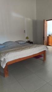 a large bed in a room with a bed sidx sidx sidx at Baobab Beach Villa 2 in Abémé