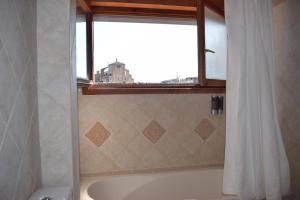 a bathroom with a bath tub and a window at Apartamento Belmecher in Estella +34 photos