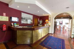 um bar num hotel com uma parede vermelha em Hotel Eurosol Gouveia em Gouveia