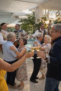 a group of people holding glasses of wine at MEDITERRANEAN SEASONS, VILLA MEDITERRANEA Taormina, Private Pool & Sea View in Taormina +90 photos