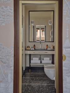 a bathroom with a sink and a toilet and a mirror at Violino d'Oro Venezia in Venice +70 photos