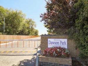 a sign for a driveway park with flowers on a wall at Dawson Park 7 - Uk12666 in Mablethorpe