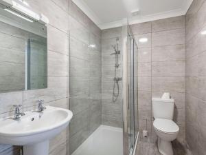a bathroom with a toilet and a sink and a shower at Dawson Park 7 - Uk12666 in Mablethorpe