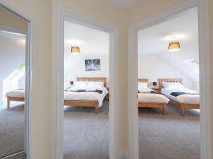 a bedroom with two beds and two mirrors at Dawson Park 7 - Uk12666 in Mablethorpe
