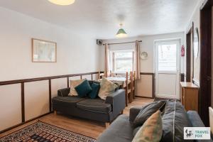 a living room with a couch and a table at Birchenfield Holiday Cottages in Dilhorne