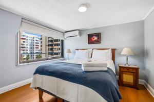 a bedroom with a large bed and a window at Isabel Suites Vitacura in Santiago