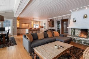 a living room with a couch and a fireplace at Cosy and central Apartment in Holo +14 photos