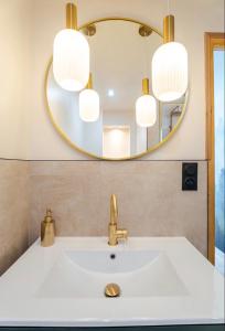 a bathroom with a sink and a mirror at Le JoliCoeur Parking gratuit Idéal cyclistes Proche Alpe d Huez in Le Bourg-dʼOisans