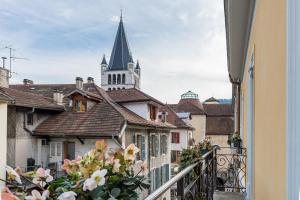a view from a balcony of buildings with a church at Hôtel La Cour du 6 in Annecy