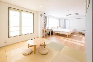 a bedroom with a bed and a table in a room at wanderlust STAY in Kofu