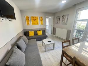 a living room with a couch and a table at Apartamentos Logroño Centro in Logroño
