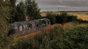 an old train sitting in the middle of a field at Boath Cabin in Auldearn