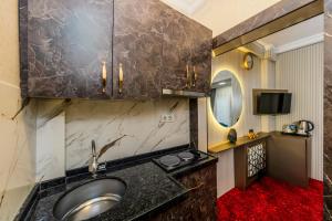 a bathroom with a sink and a mirror at Sisli Form Hotel in Istanbul +210 photos