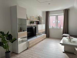 a living room with a large entertainment center with a television at Haus Anna O in Westoverledingen
