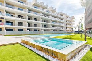 a swimming pool in front of a building at Velapi 23 in Roda