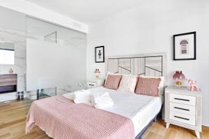 a white bedroom with a large bed with a pink blanket at Velapi 23 in Roda +28 photos