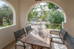 a wooden table and chairs in a room with a window at Alexia Studios in Kolios
