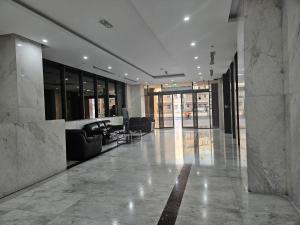 a lobby with couches and chairs in a building at Golden Homes 2 in Dubai +32 photos